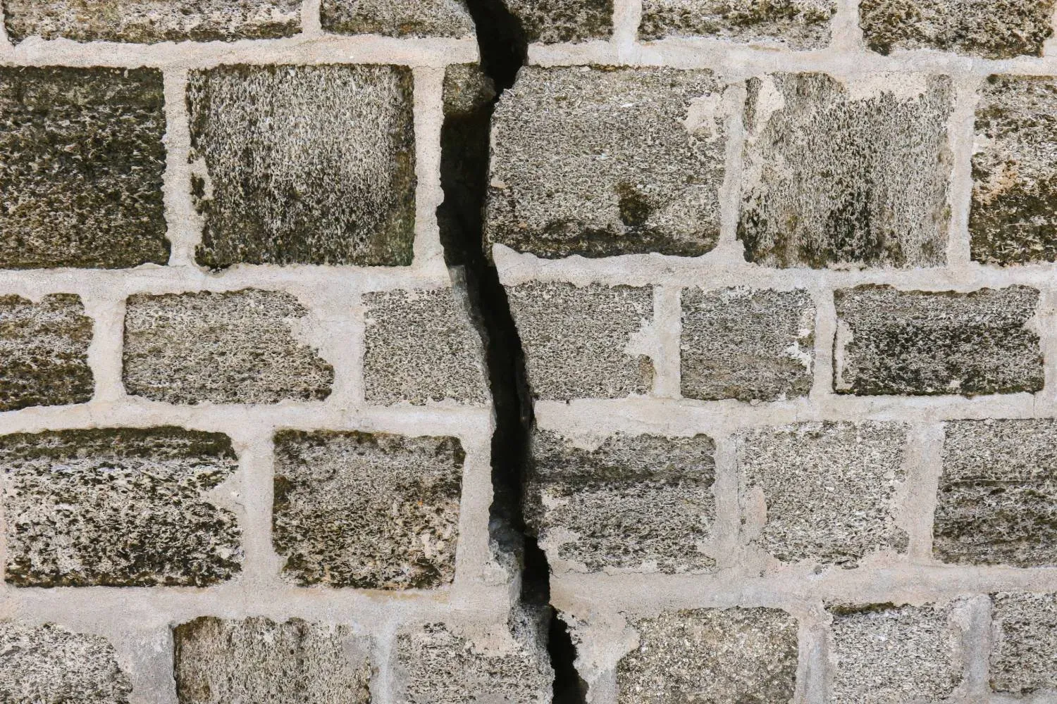Large vertical crack splitting a concrete block foundation wall in Tulsa, Oklahoma